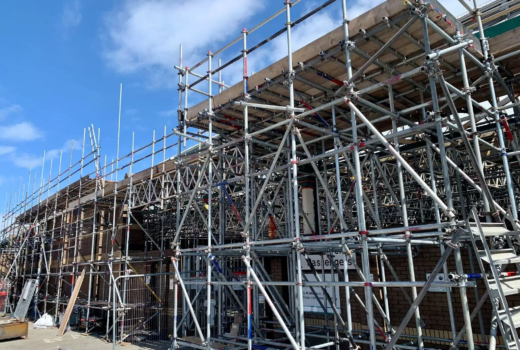 NYC commercial scaffolding setup with safety barriers on a Manhattan building.