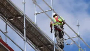 Worker on scaffolding with safety harness