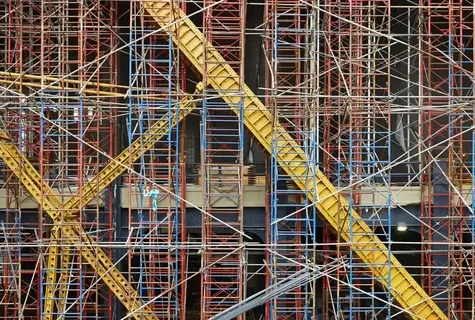 Dense network of scaffolding on a building facade.