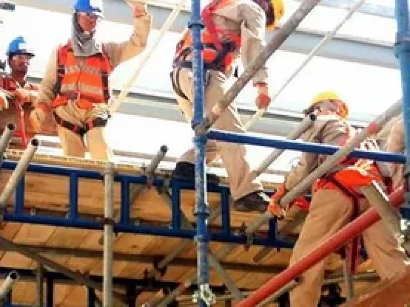 Construction crew working on scaffolding platform
